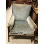A late Victorian oak framed upholstered armchair with unusual floral carved and dot inlaid
