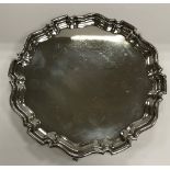 A George V silver salver in the Georgian manner with pie-crust rim,