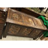 A 17th Century oak coffer, the rising lid with three plain panels within moulded stiles,