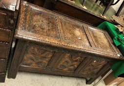 A 17th Century oak coffer, the rising lid with three plain panels within moulded stiles,
