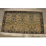 A Persian rug, the central panel set with all-over floral,