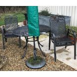 A Kettler garden table, 110 cm diameter, together with four chairs and a parasol,