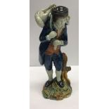 An early 19th Century Staffordshire pearlware figure of a shepherd with lamb across his shoulders