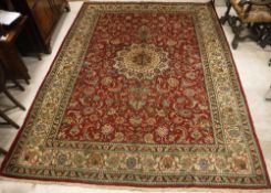 A Tabriz carpet, the central panel set w