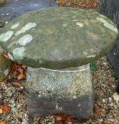 A natural stone staddle stone with circu