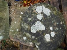 A natural stone staddle stone with circu