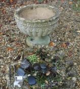 A Haddonstone type garden urn of reeded