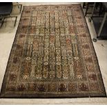 A Persian rug, the central panel set wit