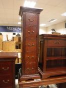 A pair of modern mahogany five drawer co