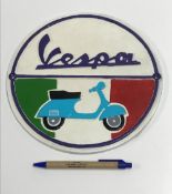 A modern painted cast metal sign "Vespa"