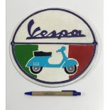 A modern painted cast metal sign "Vespa"