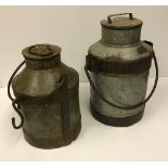 Two vintage style milk churns, one appro