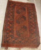 An Afghan rug, the central panel set wit