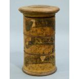 A Victorian boxwood cylindrical three compartment the lightly domed lid above three compartments