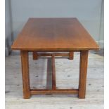 A reproduction oak refectory style dining table the rectangular top above chamfered square legs