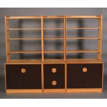 A sectional pine and brown laminate bookcase-cupboard c.1970s, comprising a pair of two-door