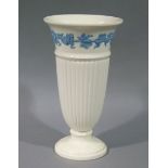 A Wedgwood embossed Queensware tall vase of fluted urnular form with moulded laurel band and rim