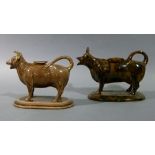 A Victorian chocolate glazed cow creamer of realistic moulded form, the back with oval aperture