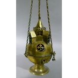 A brass hanging censer with trefoil ceiling fitment hanging chains to the globular shaped body