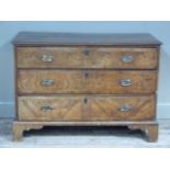 A George I walnut veneered chest, the rectangular oak top above three long drawers each with
