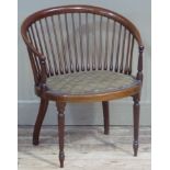 An Edwardian inlaid mahogany salon tub chair with curved railed back, the oval seat close studded on