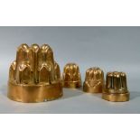 Harrods Ltd - a copper jelly mould numbered 480; together with four small copper jelly moulds,