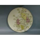 A continental pottery circular plaque, painted with flower heads and leafage, gilt detailed, 50cm