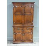 A George II style oak cupboard, the flared cornice above a pair of ogee raised fielded double