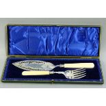 A pair of Victorian silver plated fish servers with ivory handles the blades pierced and engraved,