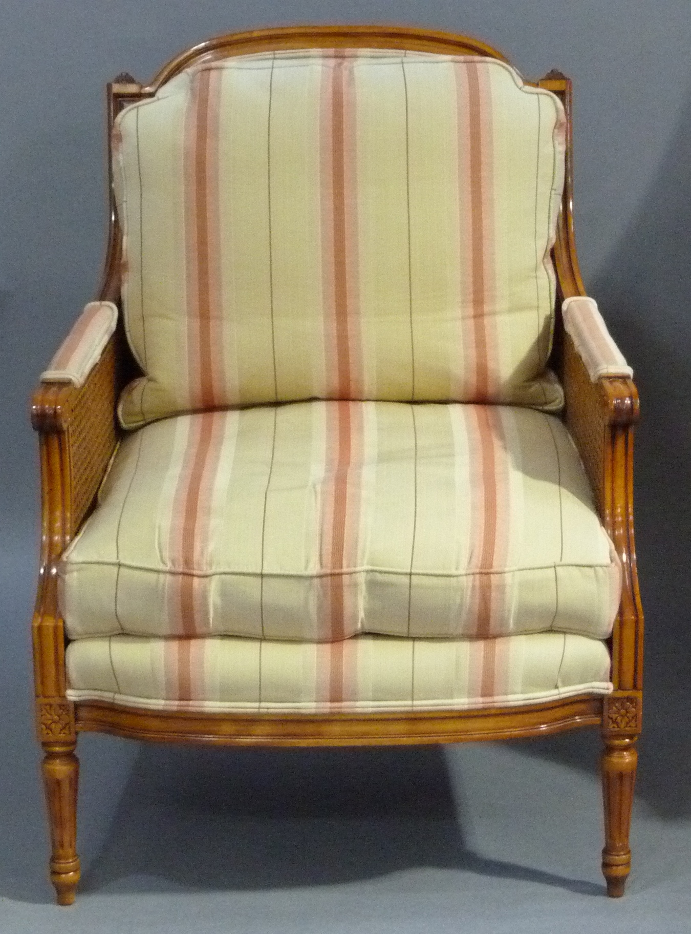 A reproduction stained beech armchair in Louis XVI style moulded frame upholstered back, arm pads