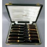 A set of six steak knives and forks with antler handles by Butlers, Sheffield England, cased