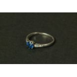 A sapphire and diamond ring in platinum c.1950 claw set to the centre with a circular faceted