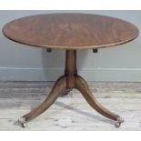 A reproduction mahogany Regency style circular breakfast table, the top with figured centre with cut
