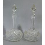 A pair of Edwardian cut glass decanters of compressed globular form with tall cut waisted necks, bud
