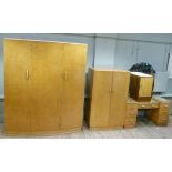 An Art Deco style three piece satin maple bedroom suite comprising gent's, lady's wardrobe and