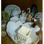 A quantity of decorative ceramics and resin figures including three graduated swan pottery