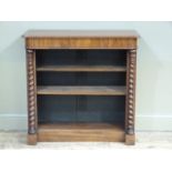 A Victorian rosewood veneered open bookcase the rectangular top with moulded rounded lip above a
