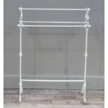 A white painted metal towel rail with foliate capped rail ends, scrolling legs, 89cm high x 65cm