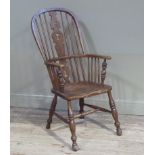 A late 19th century ash and elm highback Windsor elbow chair with pierced vasular splat and vertical