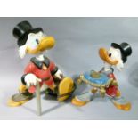 Two Donald Duck figures, 50cm high and smaller