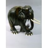 A large Coromandel carved elephant with bone tusks and toes, 36cm high