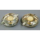 A pair of silver ashtrays of shallow circular form with pair of cigarette rests, the centres