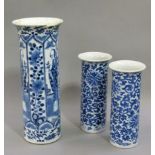 A Chinese tall cylindrical vase decorated in underglaze blue with alternate panels of figures,