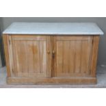 A Victorian ash cupboard with carrara marble top enclosed by a pair of panelled doors, skirted