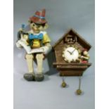 A resin figure of Pinocchio together with a resin Pinocchio clock, battery operated