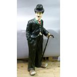 A plastic figure of Charlie Chaplin, 126cm high approximately (faults to hand)