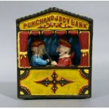 A reproduction Punch and Judy bank, 18cm high