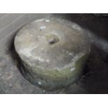 A sandstone millstone, 55cm diameter