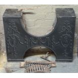 A Regency style cast iron fire insert the front cast with ribbon tied ovals with classical figures