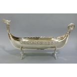 A white metal plated Norse longboat centre piece on stand, conventional form, 46cm wide